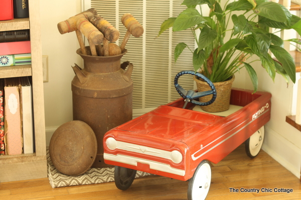 Farmhouse style bookshelf in a foyer that you really must see!  Click to get all of the details!