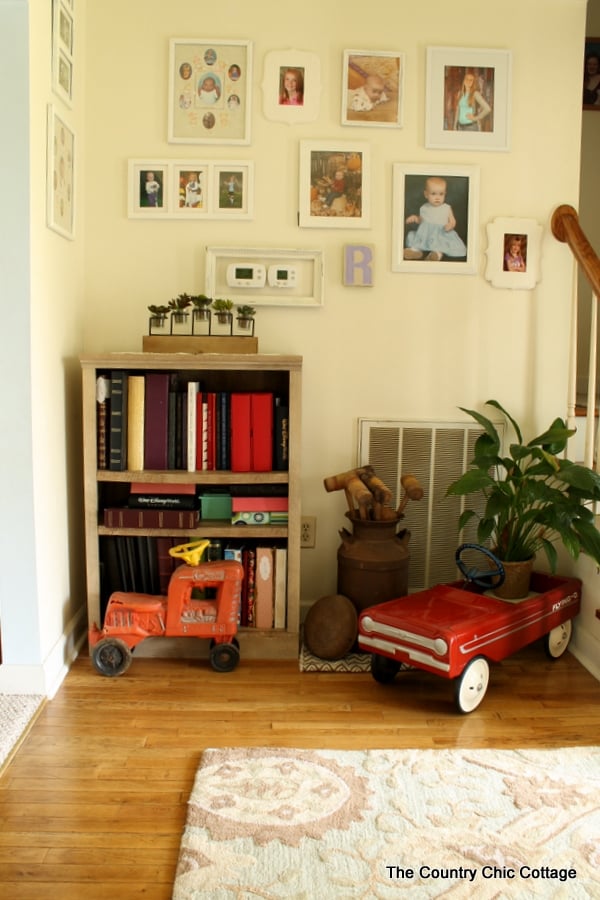 Farmhouse style bookshelf in a foyer that you really must see!  Click to get all of the details!