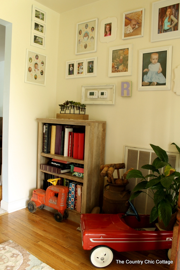 Farmhouse style bookshelf in a foyer that you really must see!  Click to get all of the details!