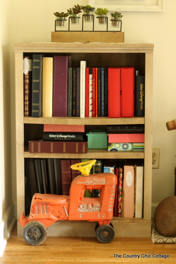 Farmhouse style bookshelf in a foyer that you really must see!  Click to get all of the details!