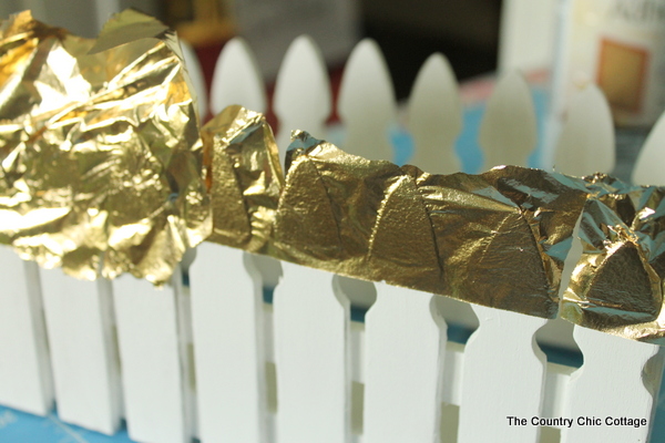 Make this picket fence planter box with a touch of gold leaf for your plants.