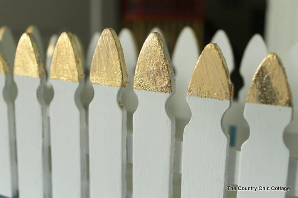 Make this picket fence planter box with a touch of gold leaf for your plants.