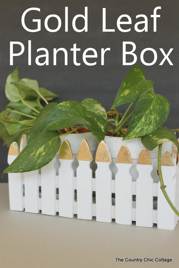 Make this picket fence planter box with a touch of gold leaf for your plants.