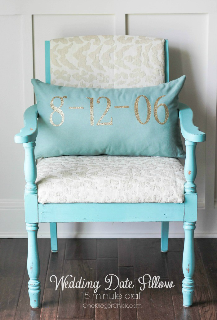 blue chair with pillow with the date in gold etched on it