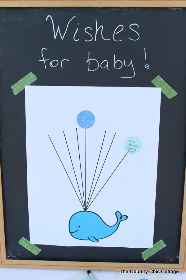 Baby shower guest book idea with free printable whale art!  Turn this fun guest book into art for baby's nursery after the shower!