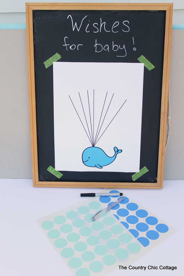 Baby shower guest book idea with free printable whale art!  Turn this fun guest book into art for baby's nursery after the shower!