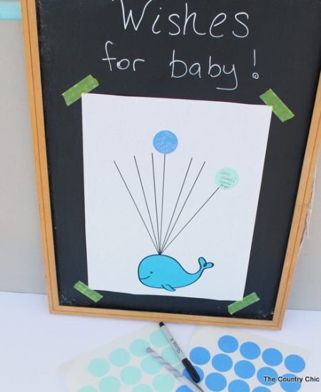 Baby shower guest book idea with free printable whale art! Turn this fun guest book into art for baby's nursery after the shower!