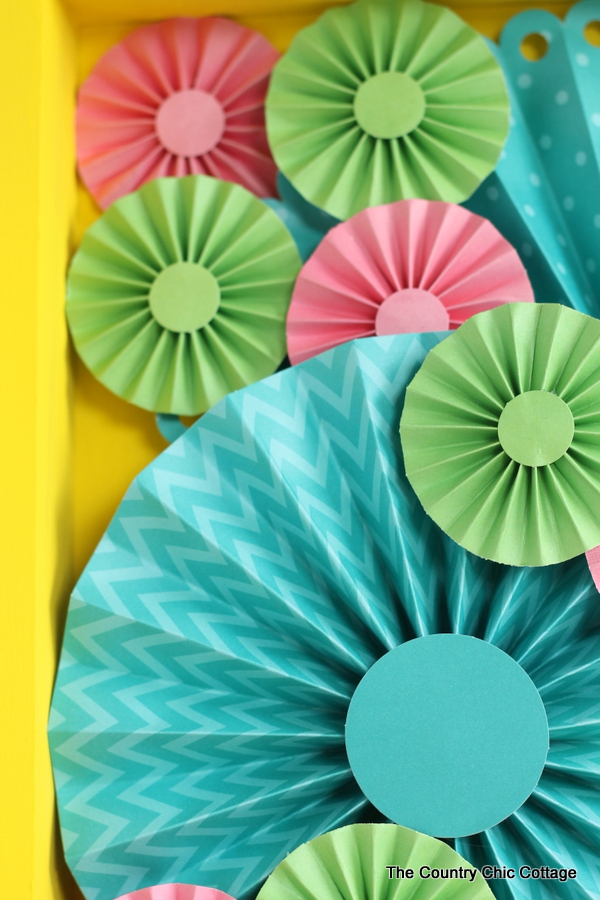 Make this rosette shadowbox art for your home! Super easy to make with a rosette craft kit!