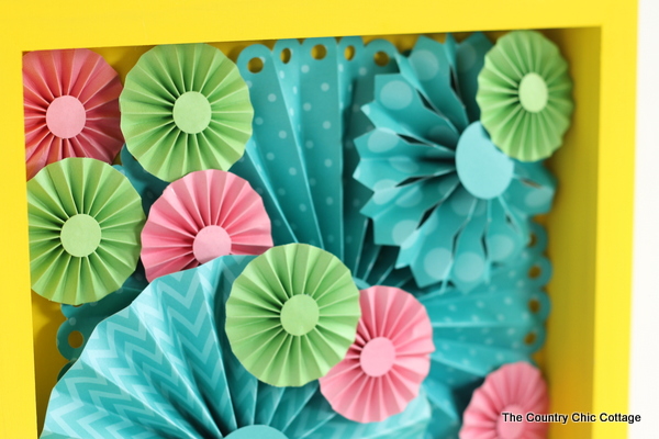 Make this rosette shadowbox art for your home!  Super easy to make with a rosette craft kit!