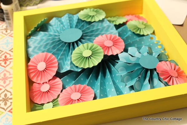 Make this rosette shadowbox art for your home!  Super easy to make with a rosette craft kit!