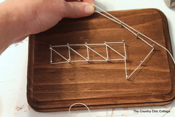 Creating geometric string art with some nails and white string