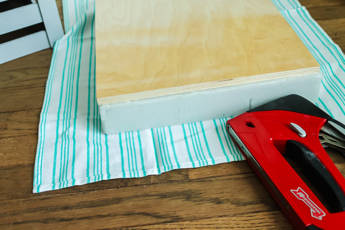 adding fabric to a stool top