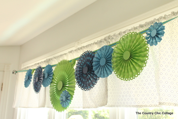 Paper rosettes in matching decor colors help bring together the Nautical Themed Baby Shower decor.
