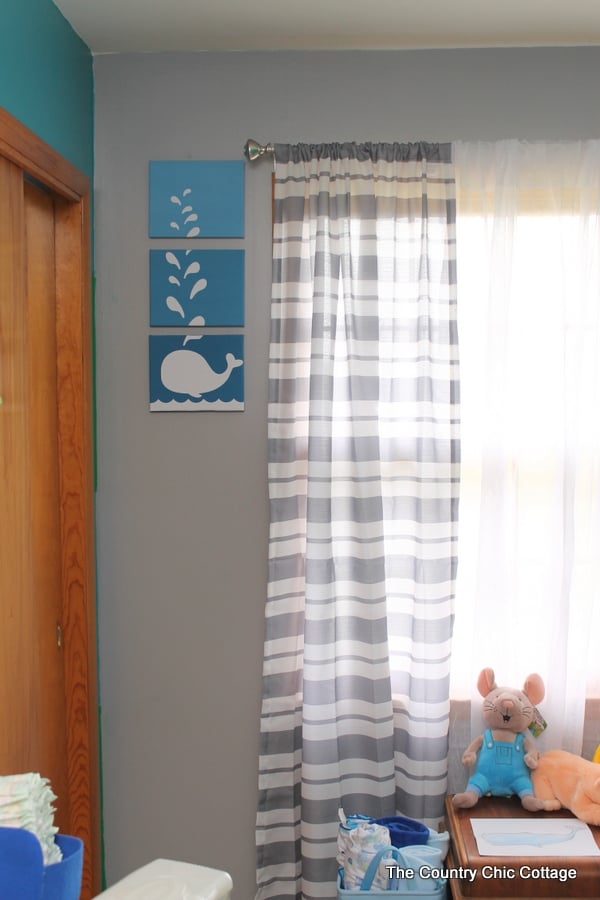 Whale art hanging on nursery wall