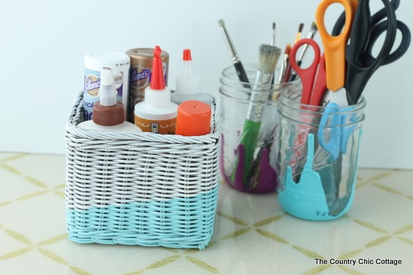 blue and white painted basket with school supplies