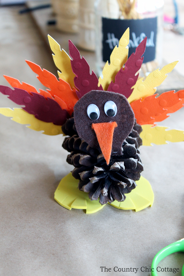 Finished craft project of a pinecone turned into a turkey.