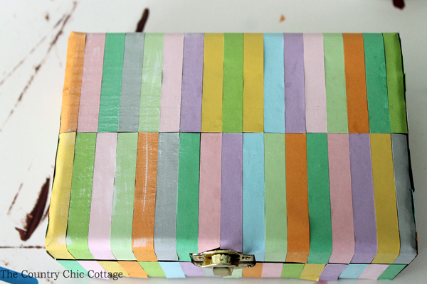 painting colored strips of paper on wooden box