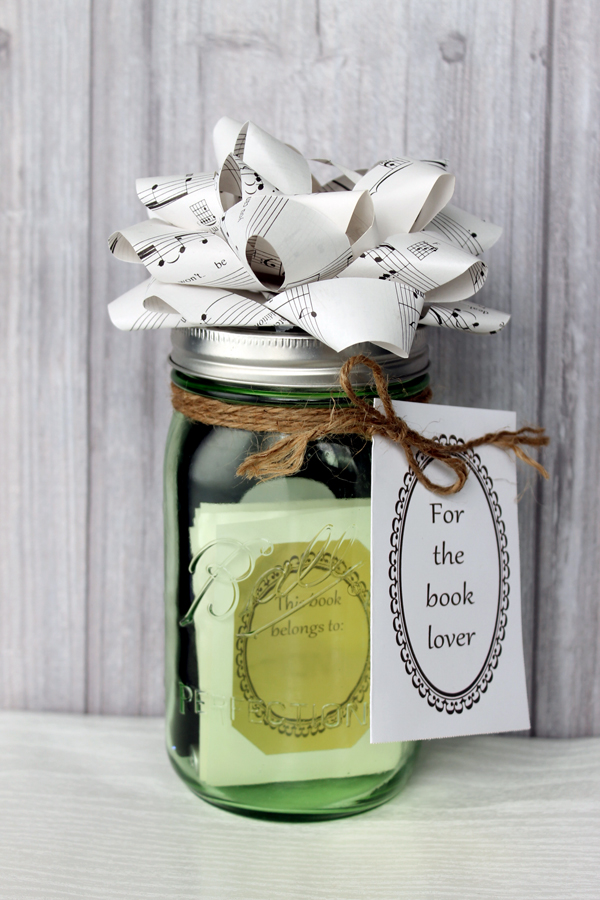 one jar filled with book gifts and topped with a paper bow