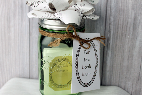 one jar topped with a paper bowl and filled with book gifts