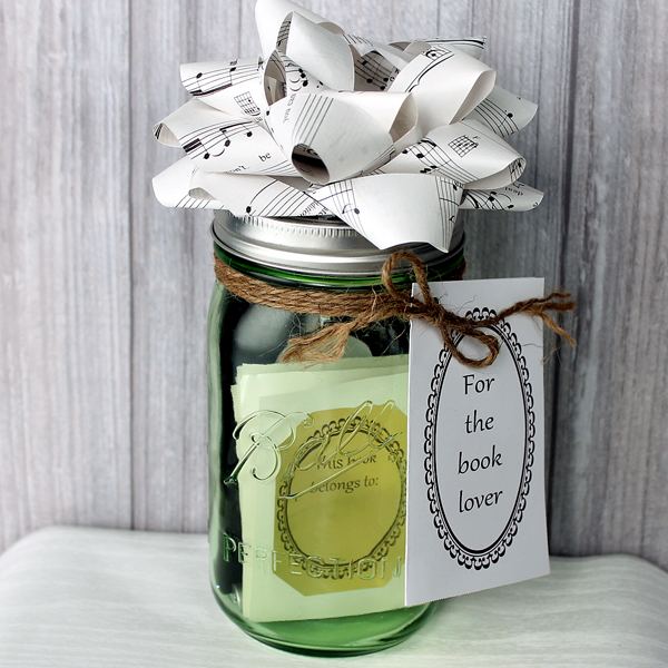 one jar topped with a paper bowl and filled with book gifts