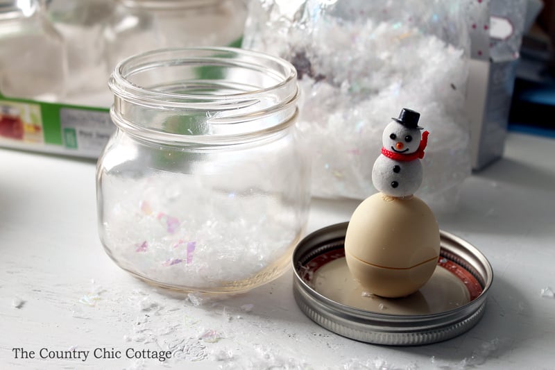 Snowman figure on top of EOS lip balm