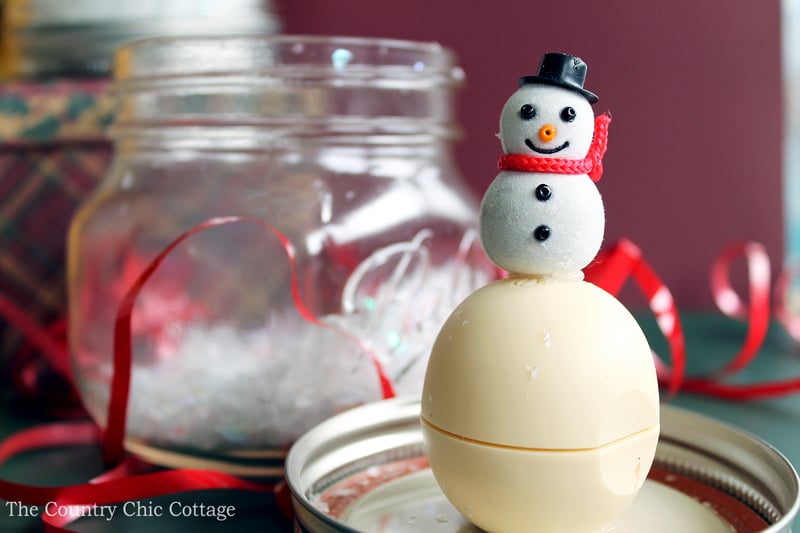 snowman figure glued on top of lip balm