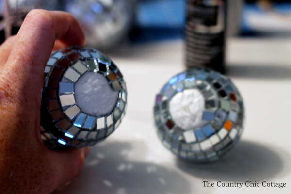 removing mirrors from the disco balls to glue them together