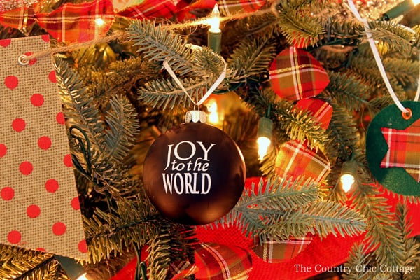 black ornaments with white vinyl that says "joy to the world"