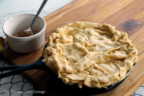Make this skillet caramel apple pie recipe today! Uses crescent rolls as pie crust for an unexpected twist! So simple to make!