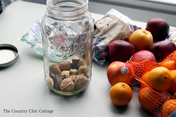 adding nuts to the bottom of a mason jar