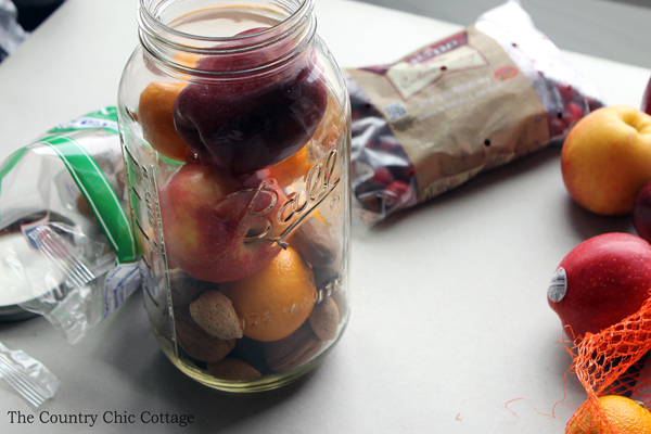 filling mason jar with fruit