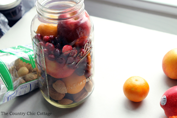 assembling fruit basket in mason jar
