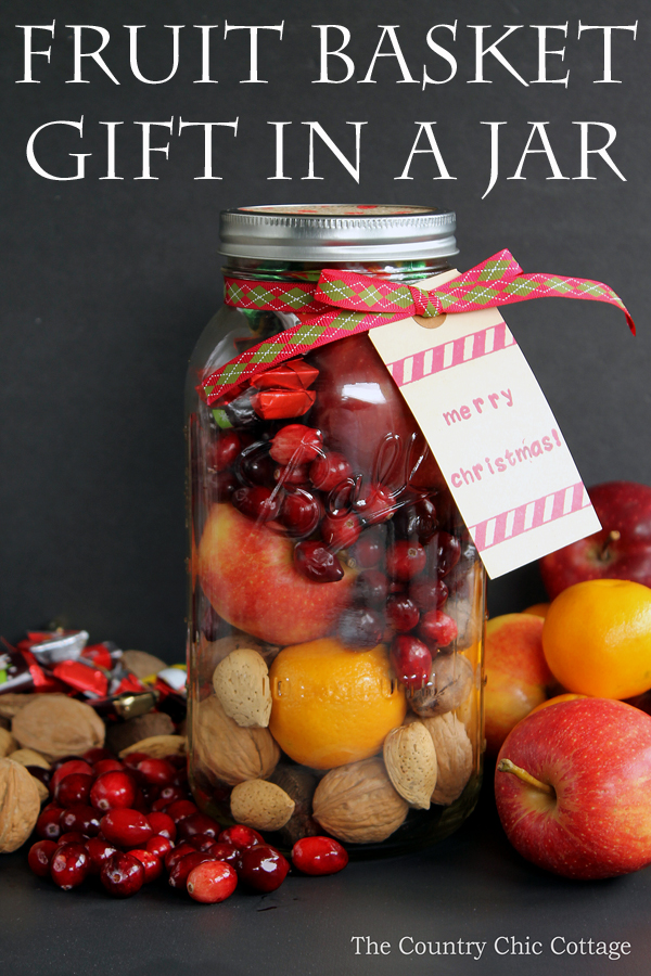 pin image with "fruit basket gift in a jar" text overlay image of assembled fruit basket in a jar with gift tag