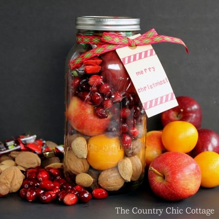 Make this fruit basket in a jar for those on your gift giving list this holiday season! This is a great traditional Christmas gift with a modern spin. It is in a very large jar from Ball that works perfectly for this gift in a jar idea!