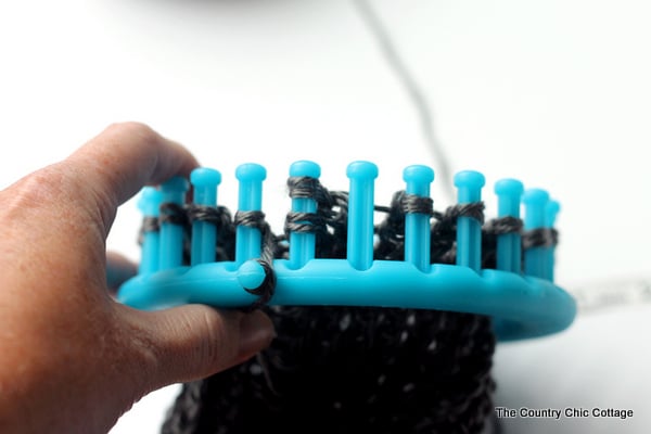 looping yarn on a knitting loom