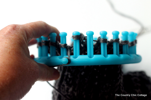 looping yarn on a knitting loom