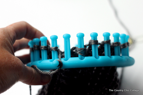 looping yarn on a knitting loom