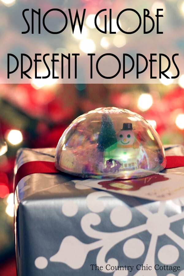 Make these snow globe present toppers for your Christmas gifts! A great addition to holiday presents in place of a traditional bow!