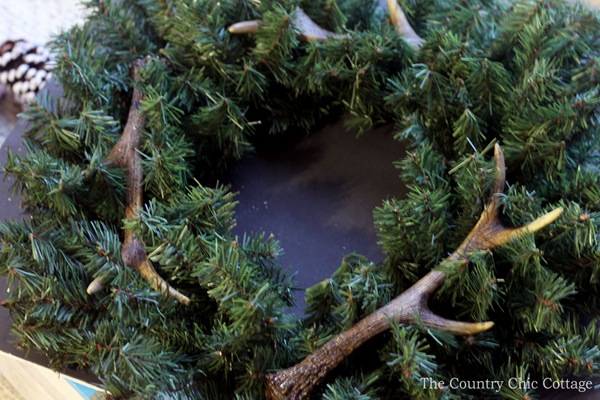 arranging antlers on wreath