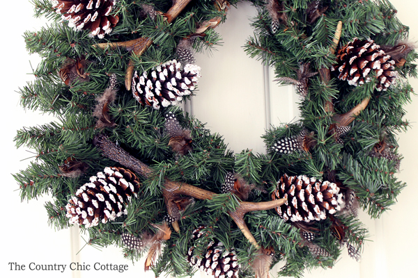 completed antler wreath hanging on door