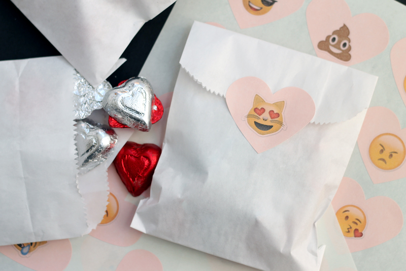 paper bags filled with candy and sealed with a DIY emoji sticker