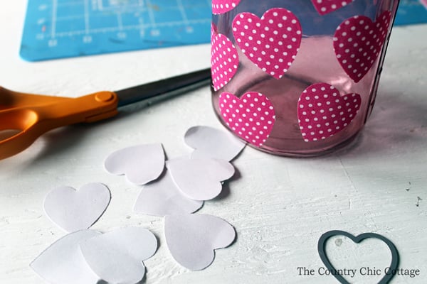 Peeling adhesive backing from heart-shaped stickers