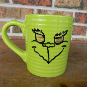 Grinch Face Mug by Artistic Endeavors 101