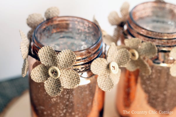  This copper mason jar centerpiece is perfect for weddings and other events! You can make this in minutes and the burlap flowers really add a rustic touch!