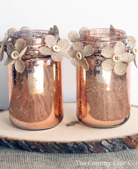 This copper mason jar centerpiece is perfect for weddings and other events! You can make this in minutes and the burlap flowers really add a rustic touch!