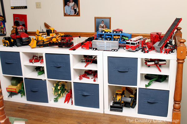 organizing toys in white cube organizer with navy canvas cubes and toys