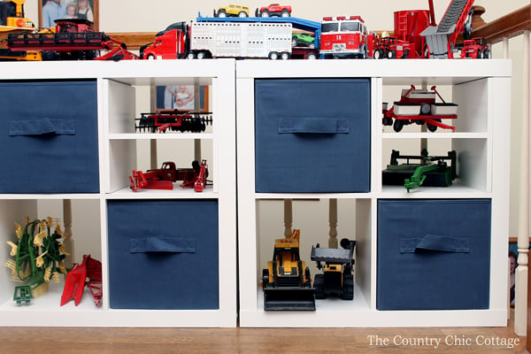 Organizing toys in white cube organizer with navy canvas cubes and toys