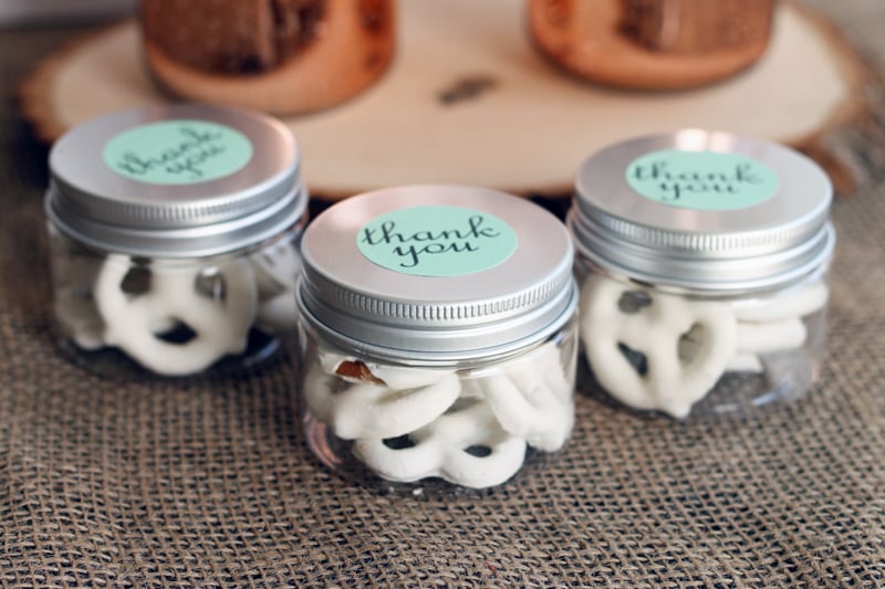 White chocolate-covered pretzels inside mason jars