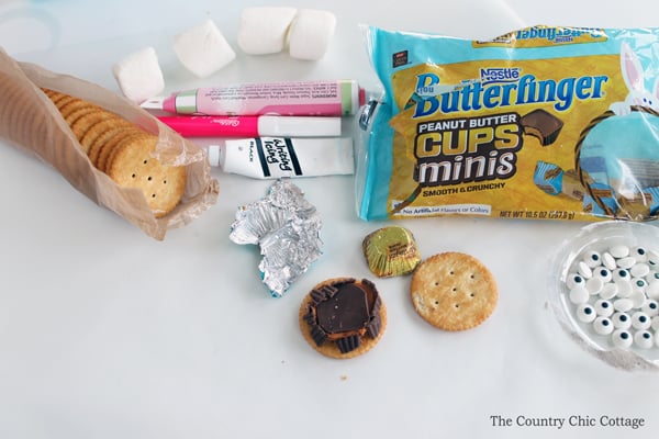 crackers, icing tubes, and butterfinger candies for making easter bunny cookies