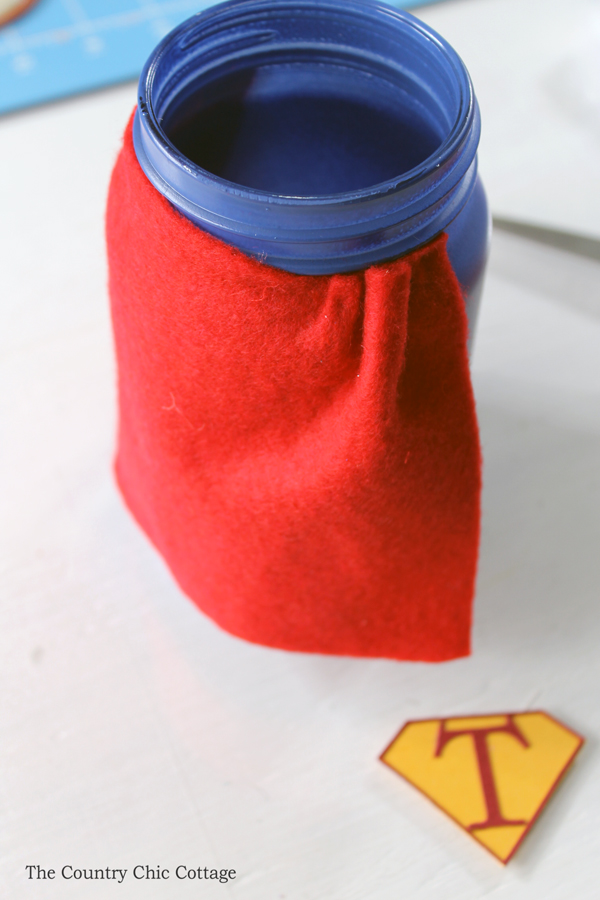 gluing red felt to mason jar for a cape